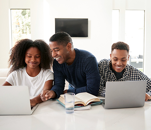 Father with his daughter and son doing homework image